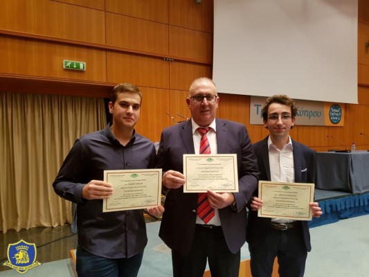 Savvas Marcou and Orestis Michaelides receiving certificates for their achievements at iGeo